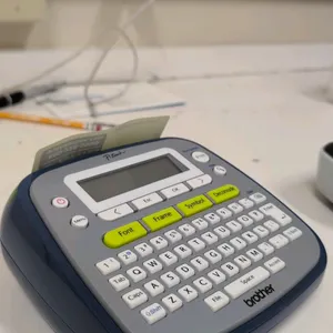 Brother PT-D200 P-Touch label maker. Features a QWERTY keyboard, graphical display, and one-touch keys for quick formatting, fonts, frames, and symbol