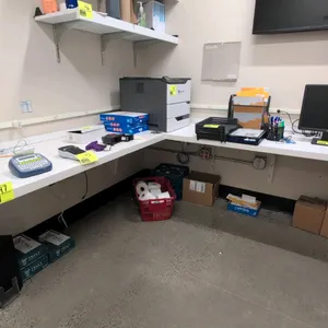 Laminate L-shaped countertop. Features a white finish. Wall-mounted installation. Dimensions: 48" x 78". Note: Printer, computer equipment, office sup