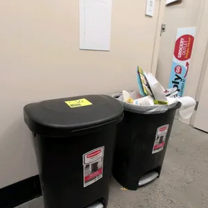 Rubbermaid Premium Step-On waste bin. Features black polypropylene construction, a hands-free foot pedal mechanism, and Liner Lock bag integration. Ca