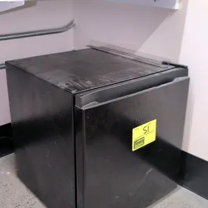 2024 Hisense WMS017M6XBE compact mini refrigerator. Features a black finish, single-door design with a small chiller compartment, one glass shelf, and