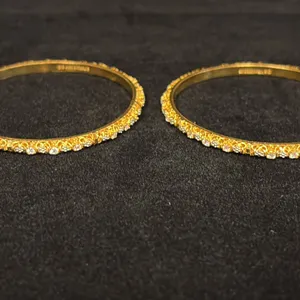 TWO APPROX 22K BANGLES SET WITH WHITE STONES (31.8G)