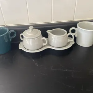 Fiesta mugs, creamer and sugar bowls with tray