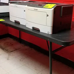 Poly folding table. Features a black plastic tabletop mounted on a black metal folding leg frame. 6'L. Contents not included.