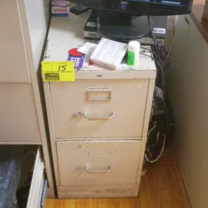 Two-drawer vertical metal filing cabinet with a beige finish. Features two drawers with pull handles and label slots. Includes miscellaneous hardware 