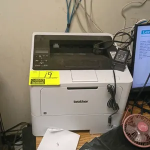 Brother HL-L6210DW wireless monochrome laser printer. Features automatic duplex printing and an LCD control panel. Background items not included.