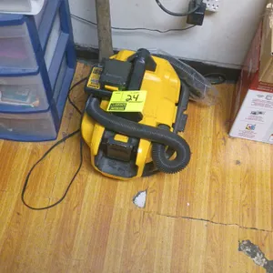 DeWalt corded/cordless wet/dry vacuum. Features integrated top carry handle, flexible hose, and AC power cord. Includes (1) battery attached.