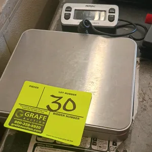 Royal digital scale. Features a 110 lb maximum capacity, a stainless steel weighing platform, and a corded remote digital display. Control interface i