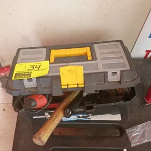 Assorted hand and power tools in a plastic toolbox. Includes a corded electric drill, a claw hammer with wooden handle, pliers, hex keys, and miscella