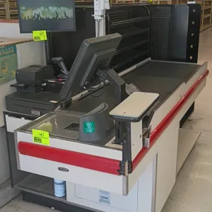 Killion single belt conveyor check lane. Features a single black conveyor belt and red bumper guard trim. 93"L. Note: Frame has laminate and particle 