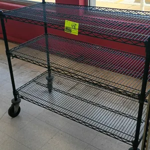 Metro 3-tier rolling wire shelving rack. Features black wire construction with three shelves. Mounted on casters with protective donut bumpers. Dimens