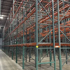 Interlake teardrop pallet racking. Features green upright frames, 3.5" orange step beams, and partial wire decking (approximately 4 decks per section)