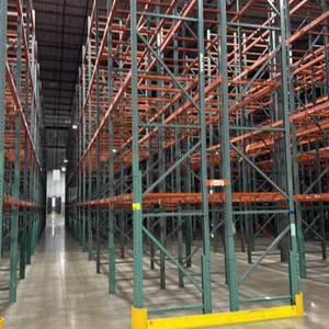 Interlake teardrop pallet racking. Features green uprights and orange 3.5" cross bars with approximately 4-decks per section. Individual bay dimension