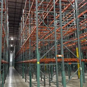 Interack pallet racking system. Includes (66) 8'L, (2) 6'L, and (4) 12'L sections. Depth: 3'8". Height: 26'H. Features green uprights and orange 3.5" 