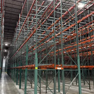 Interack pallet racking system. Includes (66) 8', (2) 6', and (4) 12' bays at 3'8"D x 26'H with 3.5" cross bars. Features green uprights and orange cr