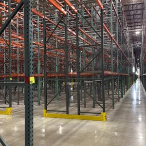 Interack pallet racking system. Includes (130) 8'L sections and (10) 12'L sections. Uprights measure 3'8"D x 26'H. Features 3.5" cross bars and wire m