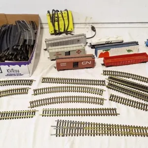 Assorted train track, train cars, and 1 power