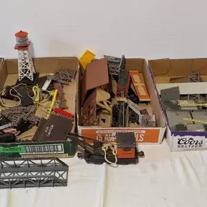 Assorted train building pieces, cars, and parts