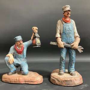 Two (2) Michael Garman Production "Engineer" Statues