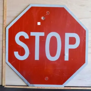 Stop sign with bullet hole Metal Sign
