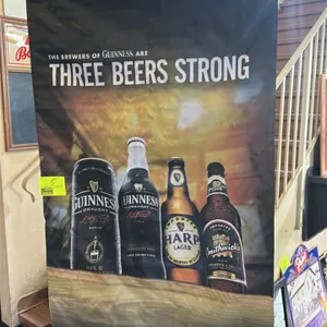 A Guinness "Three Beers Strong" Advertising Banner. (Guinness, 2011) A vinyl promotional banner featuring Guinness Draught, Harp Lager, and Smithwick'