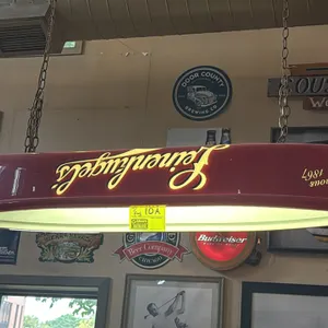 A Leinenkugel's Canoe Hanging Bar Light and Stella Artois Banner. (Leinenkugel's, 1990s-2000s) This canoe-shaped hanging bar light features a red plas