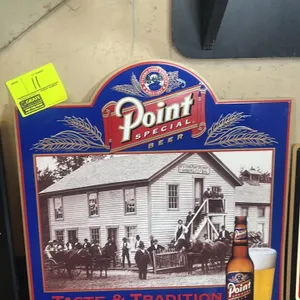 A Point Special Beer Embossed Metal Advertising Sign. (Stevens Point Brewery, circa 1990s) The sign features a historical sepia-toned image of the ori
