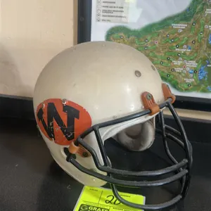 A Vintage WDP ( West DuPere) Football Helmet. (MacGregor, 1970s) This vintage MacGregor 100MH helmet features a white plastic shell with black and ora