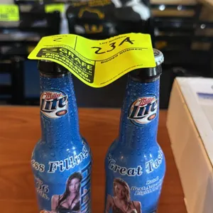 A Pair of Miller Lite "Catfight" Model Bottles. (Miller, 2003) Two collectible aluminum bottles from the iconic early 2000s "Catfight" commercial camp