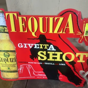 A Vintage Tequiza Beer Metal Advertising Sign. (Anheuser-Busch, circa 1999) A die-cut metal promotional sign featuring a Tequiza bottle and the slogan