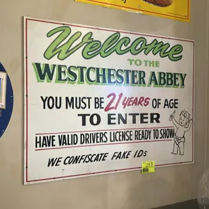 A Westchester Abbey Painted Sign. (Unknown, circa 1990s) A laminated painted sign from the Westchester Abbey golf grill and pub. The white sign featur