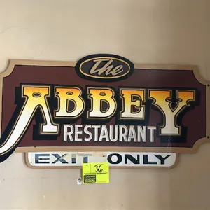 A "The Abbey Restaurant" Painted Wood Sign. (The Abbey Restaurant, n.d.) An original dimensional wood directional sign reading "The Abbey Restaurant" 
