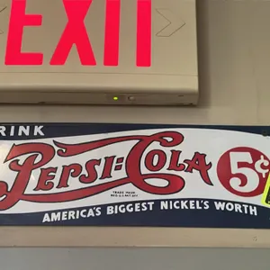 A Vintage Pepsi-Cola Metal Sign. (Pepsi-Cola, Mid-20th Century) A classic single-sided metal advertising sign featuring the Pepsi-Cola logo with "DRIN