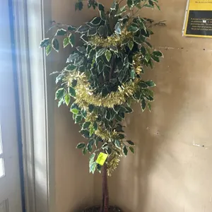 Decorative artificial plant. Features variegated green and white foliage, a realistic trunk, and is set in a woven wicker planter basket. Includes gol
