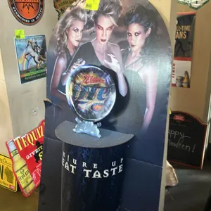 A Miller Beer Halloween Cardboard Standee Display. (Miller Brewing Co., 2009) Features a spooky theme with three women and a lenticular "crystal ball"