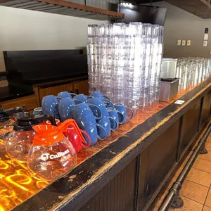 Coffee pots w/ coffee mugs & beer glasses & plastic glasses