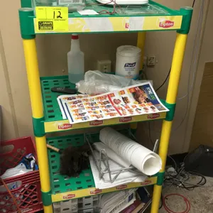 Lipton branded multi-tier poly display rack. Features 4-tier design with green plastic slotted shelves and yellow plastic uprights. 24"x18". Contents 