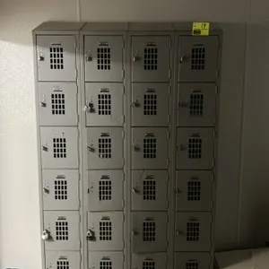 Metal 6-compartment employee locker bank. Features 4 connected columns with a total of 24 individual compartments. Equipped with louvered ventilation 