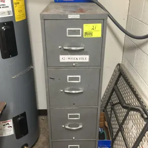 HON 4-drawer metal vertical filing cabinet. Features pull handles and label holders. Measures 28"x15"x52". Contents not included. Note: Rust present o
