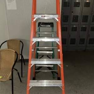 Werner 6' fiberglass A-frame stepladder. Features orange fiberglass rails, slip-resistant aluminum rungs, and a black plastic top cap with integrated 
