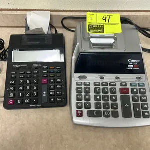 Printing calculator lot. Includes (1) Canon MP11DX 12-digit printing calculator with clock and calendar, and (1) Casio HR-170RC 12-digit printing calc