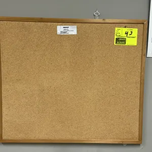 Wanzl 27"x23" corkboard. Features a wood frame. Lot tag indicates whiteboard on reverse side. Wall-mounted. Background items not included.
