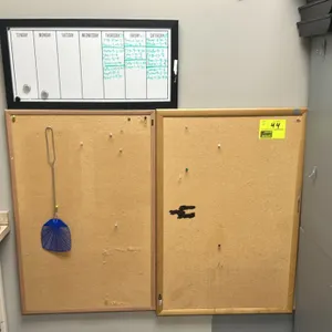 Office board group. Includes (2) 23"x36" cork bulletin boards with natural wood frames and (1) 26"x13" weekly calendar whiteboard with a black frame. 