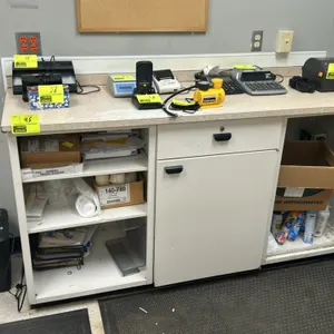 Laminate counter with cabinets. Features a 74"x24" laminate countertop, an open under-counter shelving section with adjustable shelves, a center stora