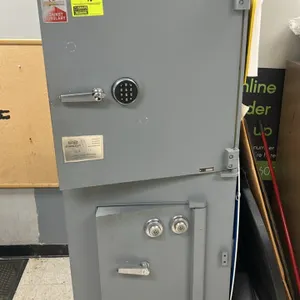 Mosler dual-chamber metal deposit safe. Top chamber features a digital keypad lock, adjustable interior shelving, and door-mounted document slots. Low