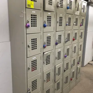 Win-Holt 18-compartment metal employee locker unit. Features a 3-wide, 6-tier configuration with ventilated doors and padlock hasps. Approx. 36"W x 12