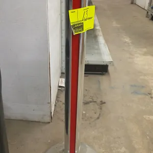 Alvarado Escort crowd control stanchion. Features a polished chrome finish with a red accent stripe, integrated 4-way top connector, and a weighted ro