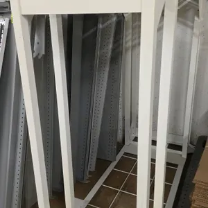 Metal merchandiser rack. Features white metal frame construction and a grid bottom shelf. Includes an assortment of loose grey metal display bars and 