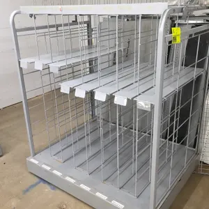Portable merchandiser rack. Features a gray painted metal frame with wire grid dividers and flat display shelves. Designed for retail product display.