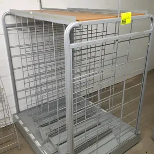 Portable merchandiser rack. Features wire dividers, a wood laminate top shelf with a wire sign holder, and a grey metal frame. The base includes slots