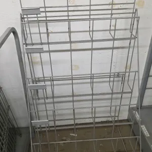 Wire merchandiser rack. Features gray wire construction with a four-tiered display design, integrated ticket holders, and a folding rear support frame